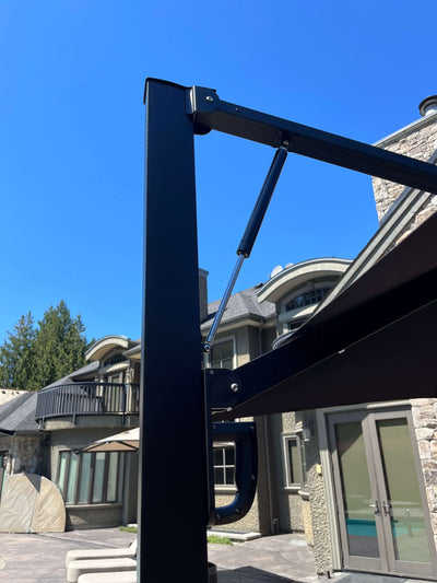 Close-up of RM Sun Unbrella cantilever with rotatable design, showing sturdy frame and mechanism in a sunny outdoor setting.