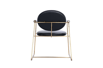 Mera chair with bent metal frame and upholstered seat in black leather, featuring a stylish gold finish.
