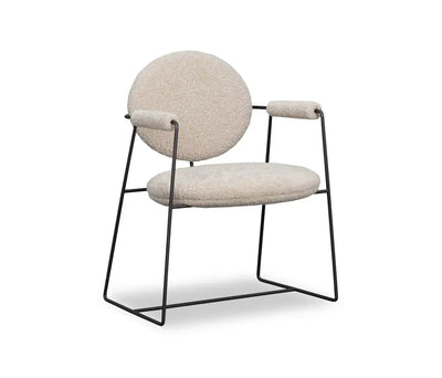 Mera dining chair with a round back, upholstered seat, and black metal frame; perfect for stylish dining rooms.
